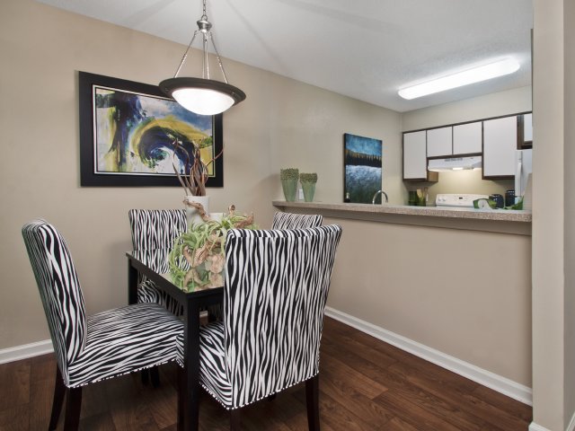 Dining area with wood-like floors close to kitchen