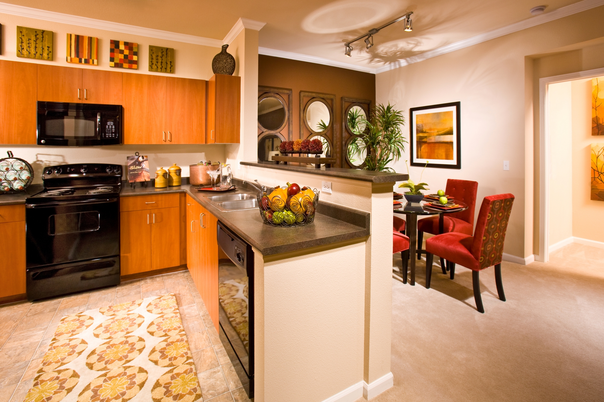 Kitchens with cherry cabinetry and black GE appliances