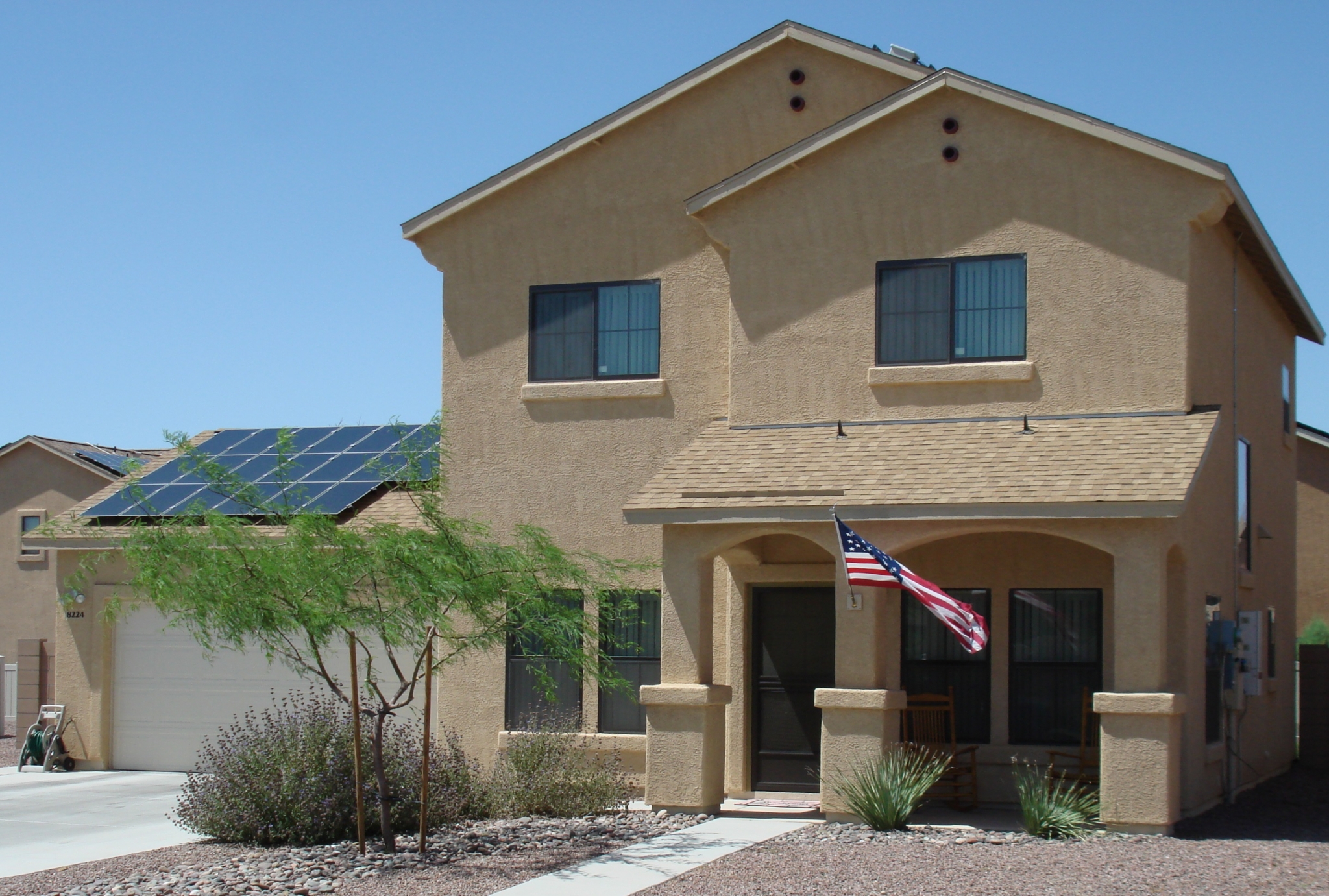 Two story home with american flag